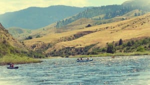 a raft and inflatable kayak float down hells canyon on a snake river rafting trip