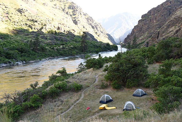 Tent camping in the beautiful Hells Canyon on the Snake River during a multiday rafting trip.