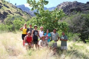 a group poses in front of an apricot tree during a 3 day hells canyon rafting trip
