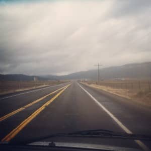 road to the clearwater: open road with mountains in the background