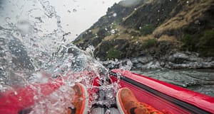 a kayaker gets splashed in a hells canyon rapid while on an overnight trip