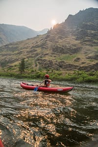 a kayak leisurely floats down the snake river in the afternoon