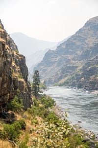 the snake river flows through a smoky hells canyon during a whitewater rafting trip