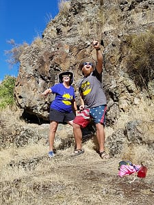 2 people point and laugh away from the camera at the 2017 eclipse in hells canyon during a rafting trip