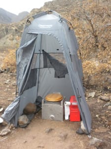 a tent erected over a river toilet called a groover on a multiday whitewater rafting trip