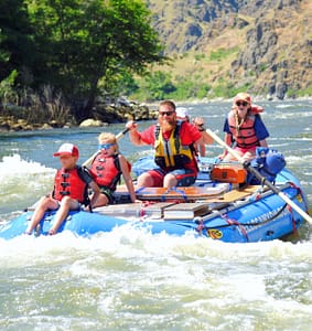 kids and a guide whitewater raft on a hells canyon rafting trip
