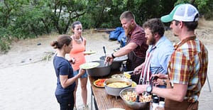 rafting guides serve dinner on a snake river whitewater rafting trip