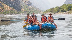 A river guide rows a group down Hells Canyon on the Snake River