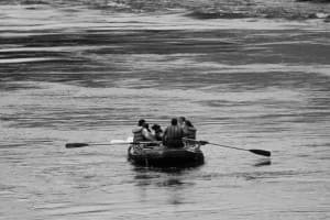 a full paddle boat floats away on the snake river during a white water rafting trip