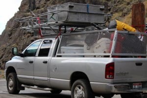 a gray truck is packed full of boats, coolers, life jackets and everything else needed for the best trip down the Snake River in Hells Canyon