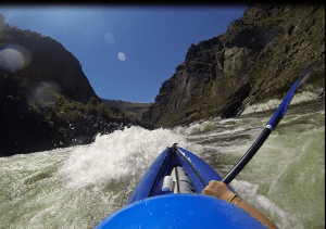 a snapshot of go pro footage of a inflatable kayak going through the whitewater of the salmon river